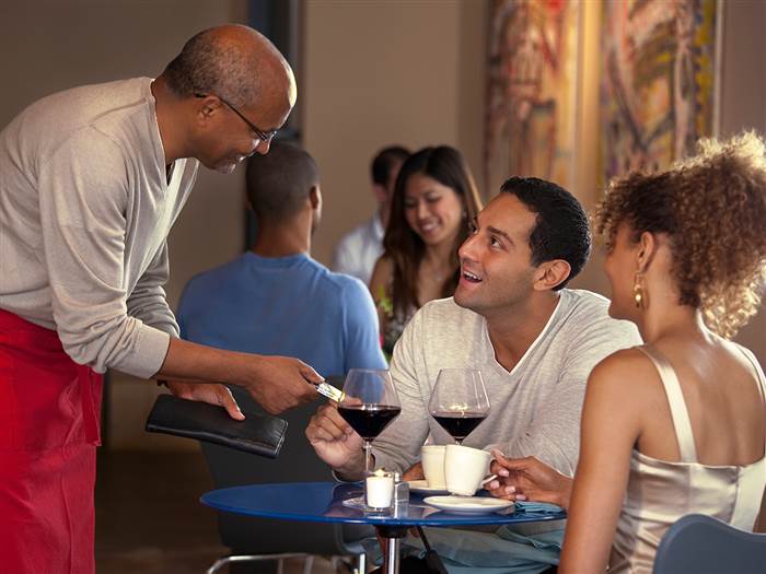 man paying for date, date night, couple